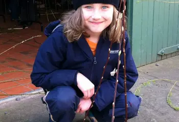 A young person taking part in willow weaving 