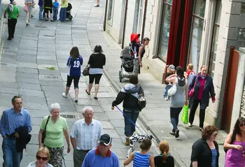 Visitors and shoppers on a street in Stromness