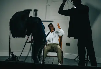 Person sitting using microphone