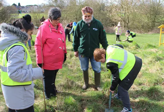 Volunteers planting a tree