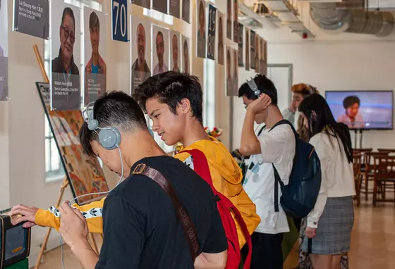 Young people engage in the exhibition and listen to the interviews on a headset