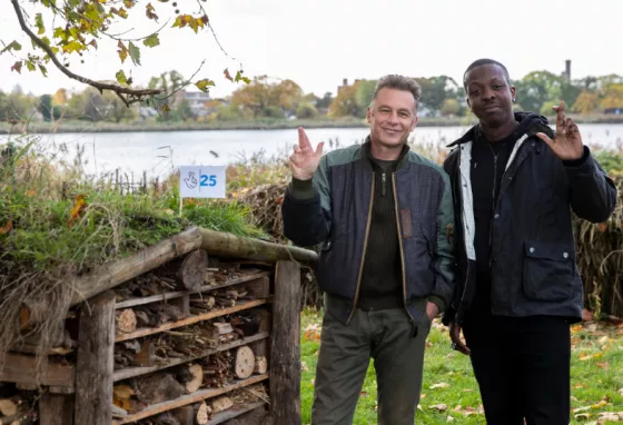 Chris Packham and Jamal Edwards crossing their fingers like the National Lottery logo