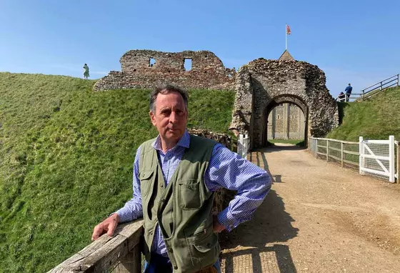 Edward on a sunny day, standing in front of some historical ruins