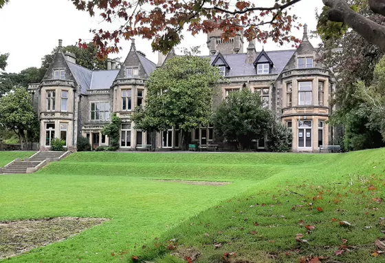 A large mansion with lawn in front