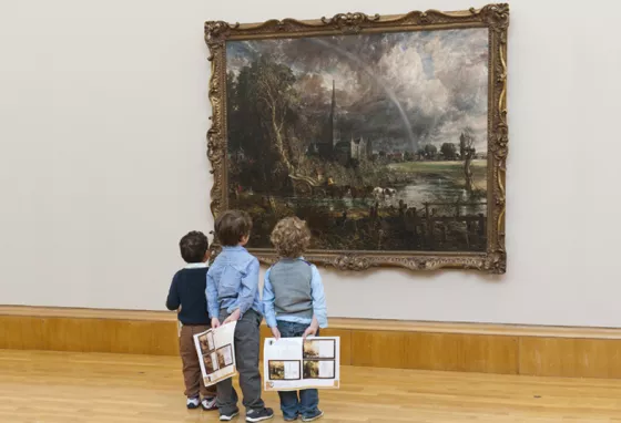 Three children look at Constable painting 