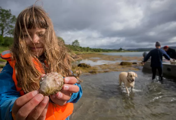 Young girl holding an oyster