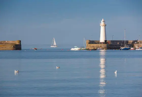 Donaghadee Harbour with a lighthouse and a number of boats.