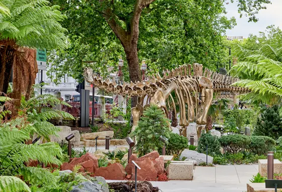 A life-size bronze cast of a dinosaur skeleton in the new gardens surrounding the building