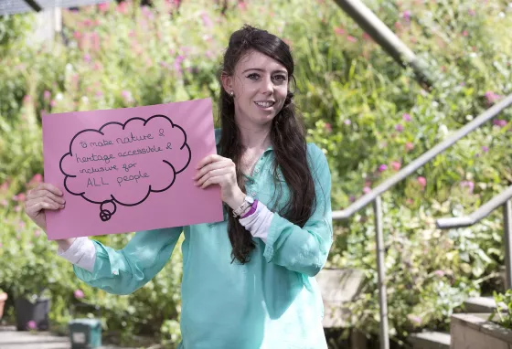 Young woman holding sign