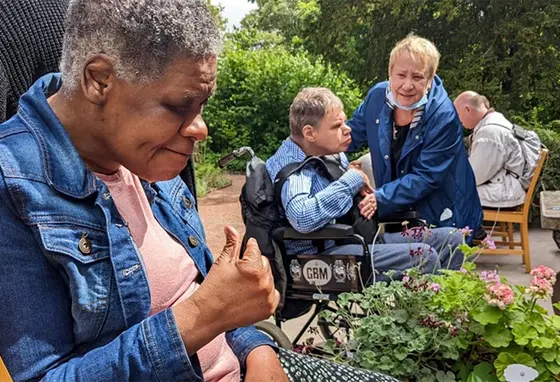 Adults with complex care needs in a garden