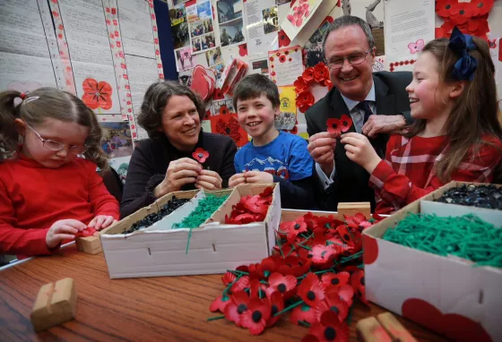 Children and adults making poppies