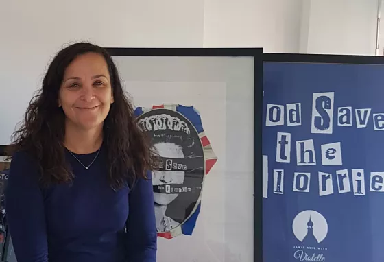 Anne Lundon, Chief Executive of the Florrie, smiles in front of campaign artworks