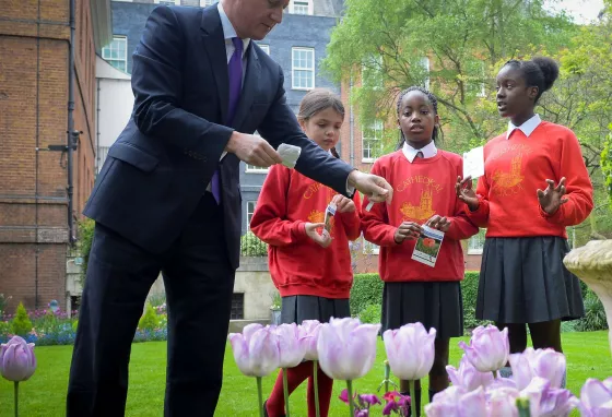 The Prime Minister planting poppy seeds with local school children