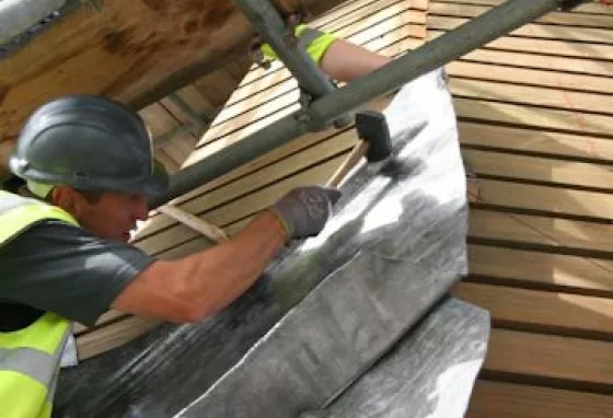 A man repairs the roof at Canterbury Cathedral