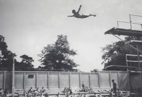 A man dives from the diving board at Broomhill Pool