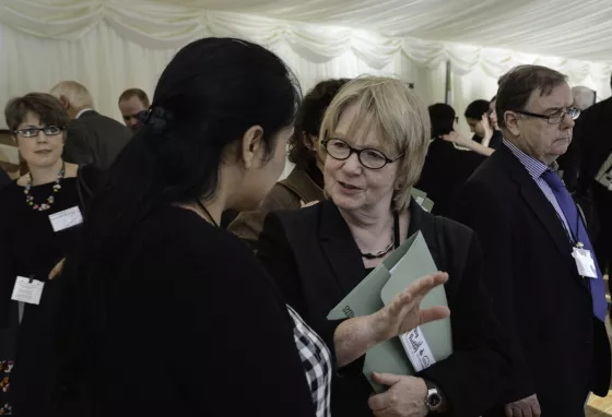 Dame Seona Reid talks to a woman at an event