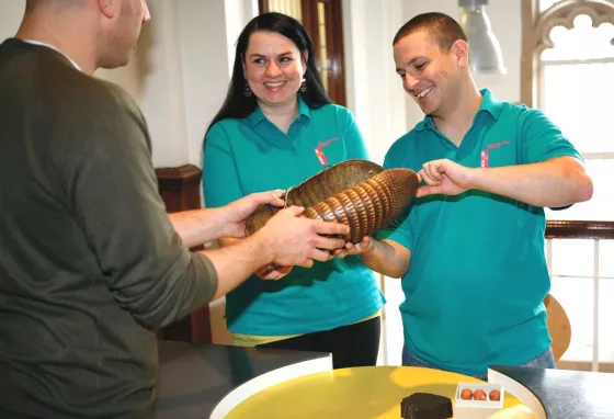 Volunteers showing handling objects at the Migration Museum