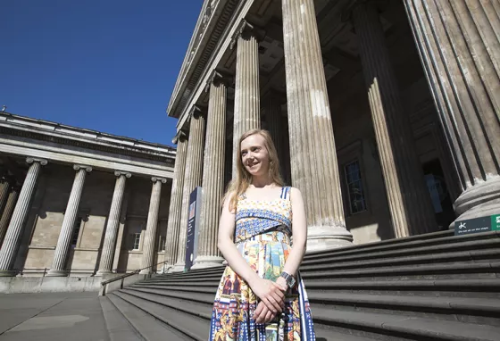 Jessica Starns stands outside the grand British Museum building, smiling