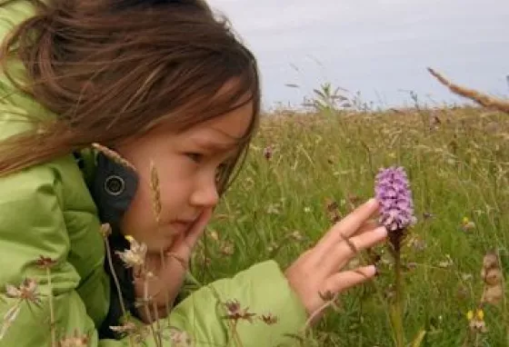 Girl looking at an orchid