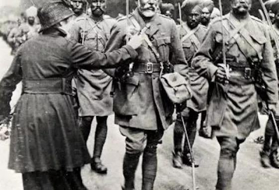 A lady pinning a flower onto a Sikh soldier in 1916