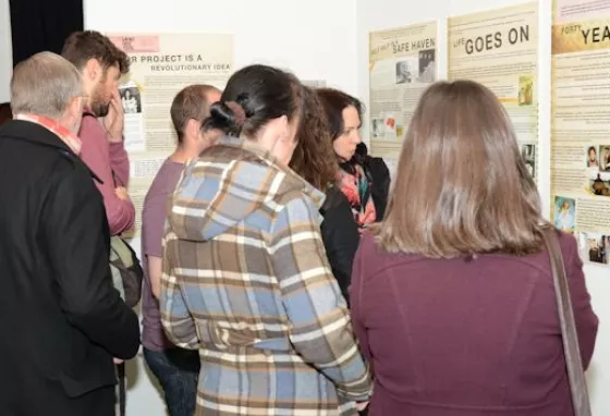 People visiting a Children of the Croft pop-up exhibition