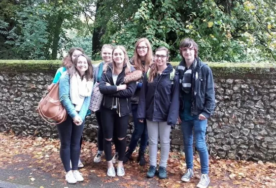 A group of young people in front of a wall