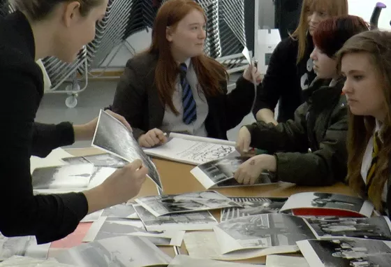 Students look at historic photographs