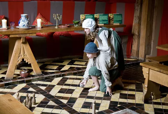 Children dressed in Tudor costume playing skittles in Barley Hall