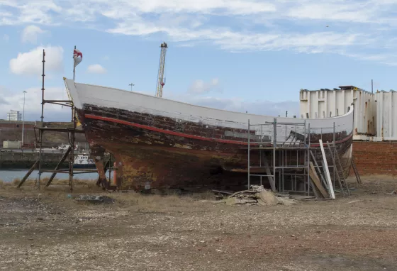 The hull of a boat being repainted