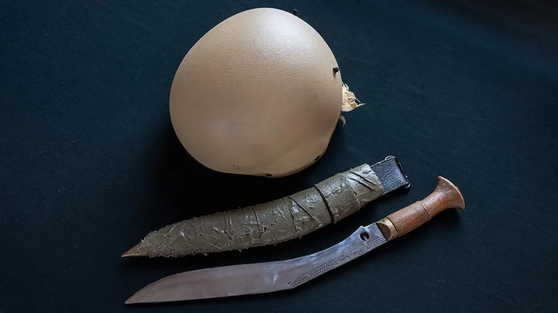 The modern military khukhuri and helmet that belonged to Rifleman Tuljung Gurung