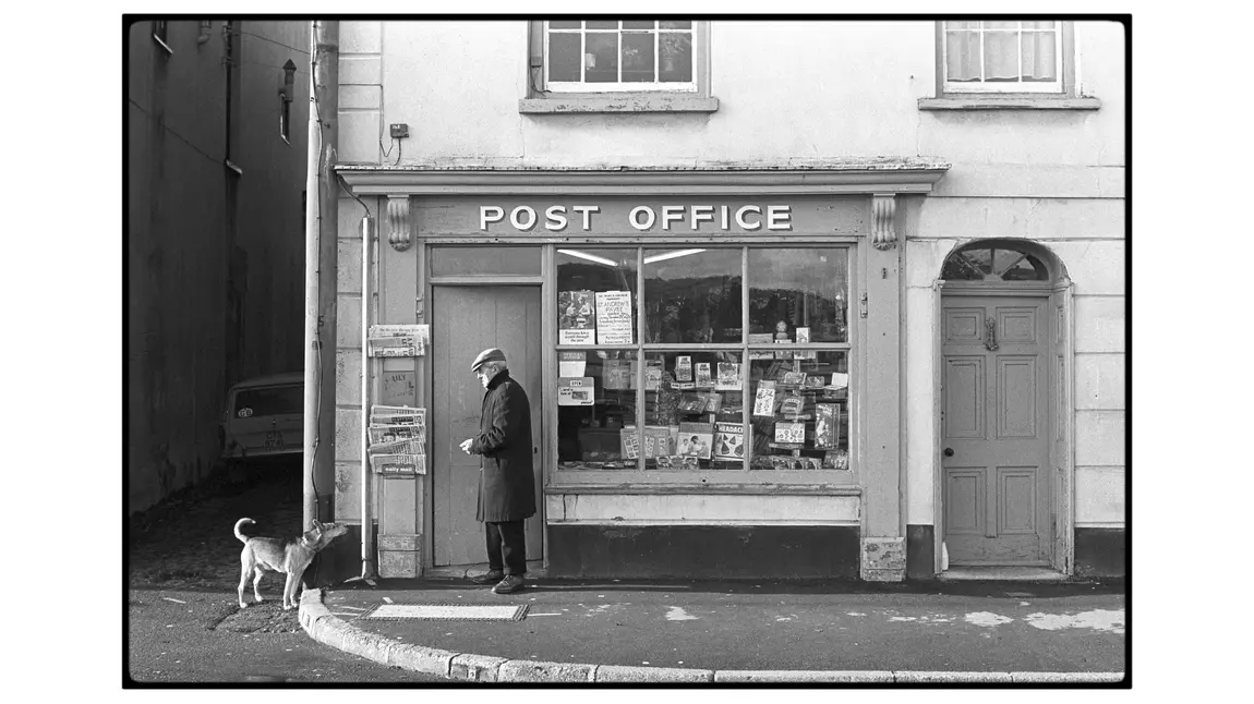 A man and his dog pictured outside a post office