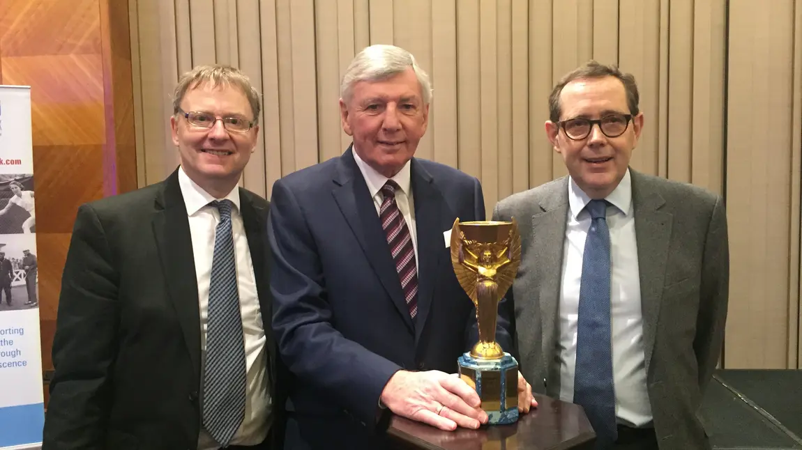 HLF's chair Sir Peter Luff pictured with the Jules Rimet trophy, World Cup player Martin Peters and Kevin Moore, Director of the National Football Museum