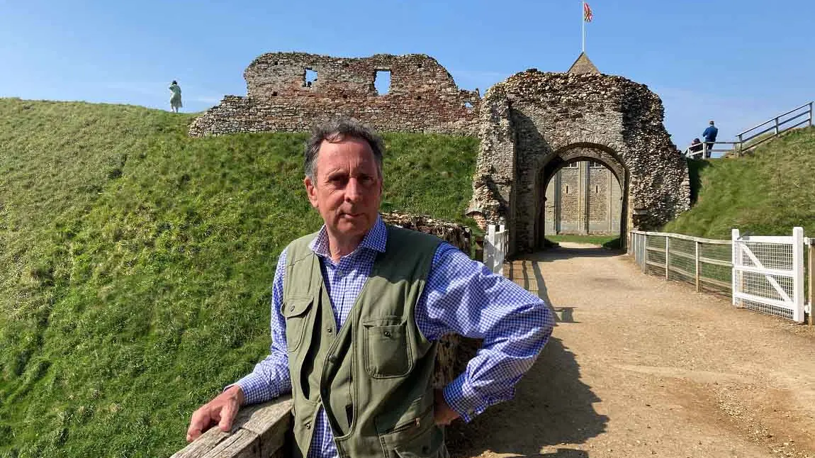 Edward on a sunny day, standing in front of some historical ruins