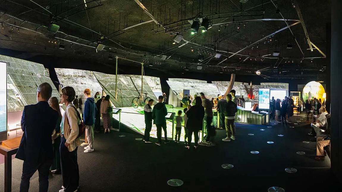 People inside building looking at exhibits