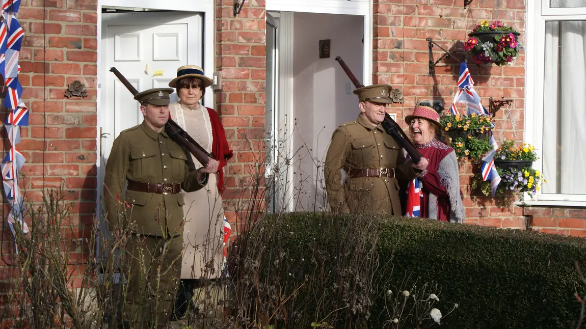 Two men dressed as soldiers standing at their front door