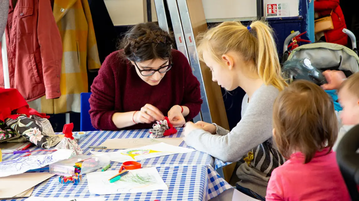 Woman making crafts with children