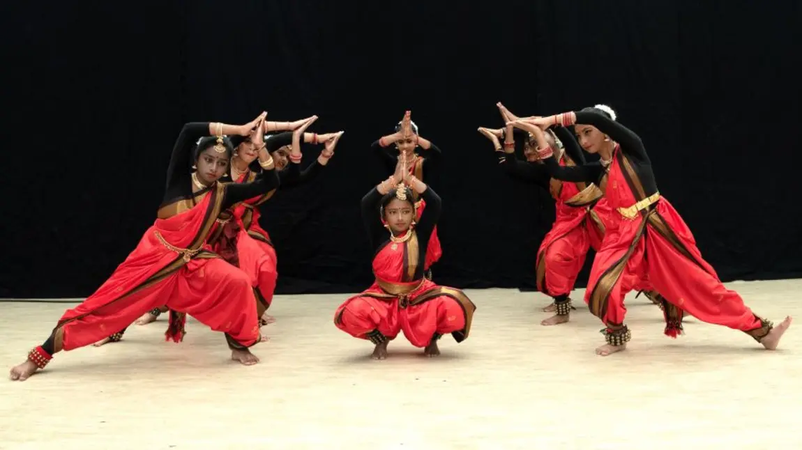 A group of young people perform an Indian classical dance called Bharatanatyam.