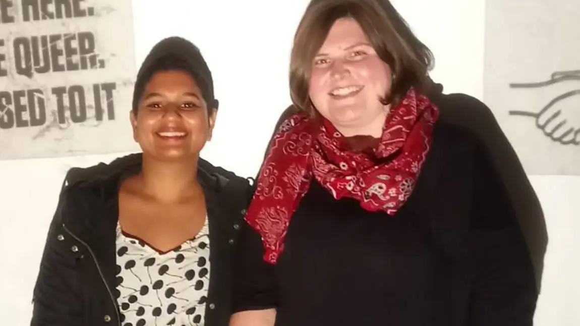 Two women at queer exhibition