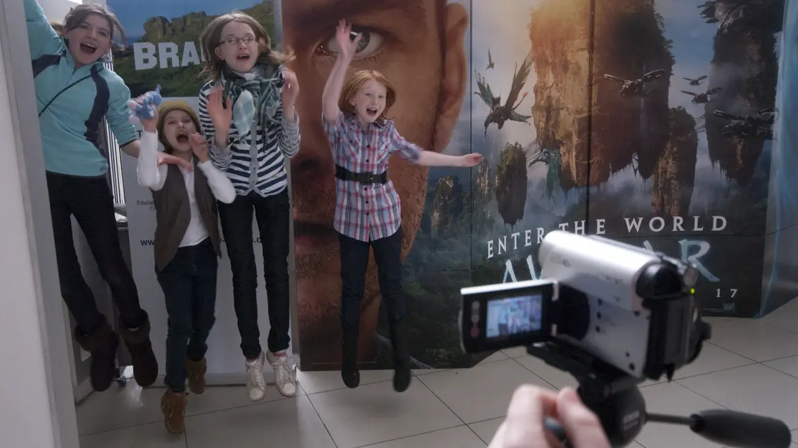 Children jump in front of a video camera