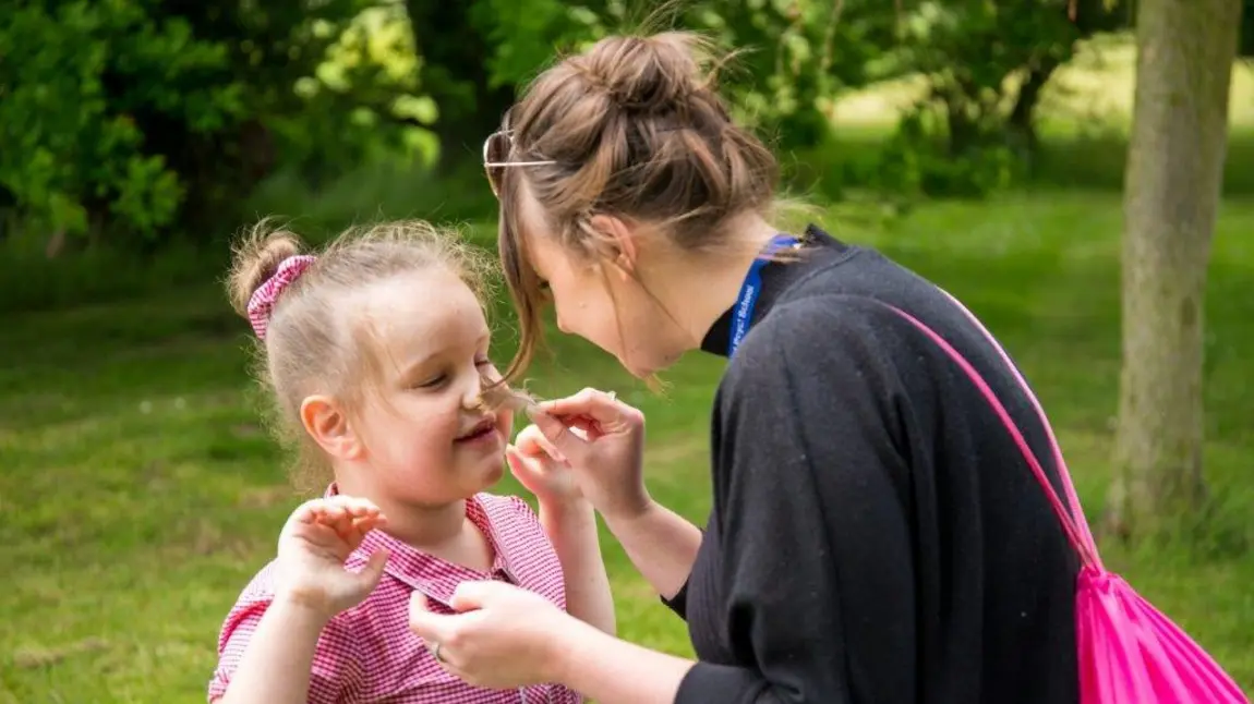 A little girl discovers the outdoors through sensory activities