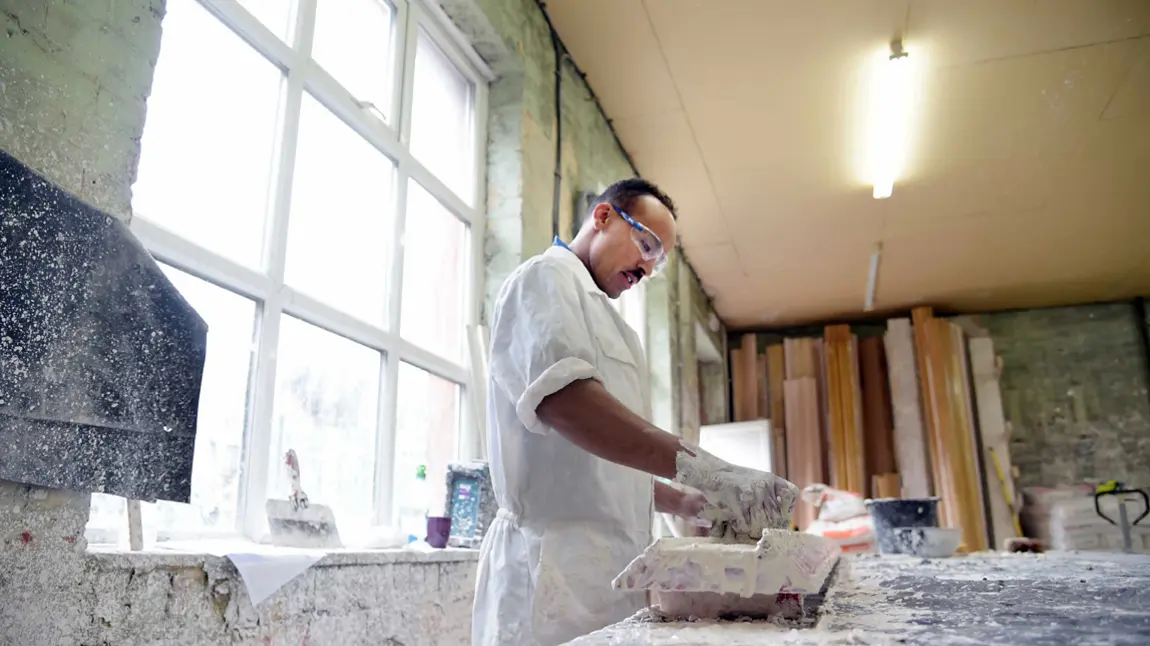 A man works with plaster