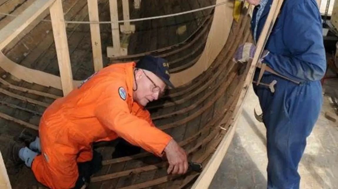 Apprentices learning traditional boat building skills