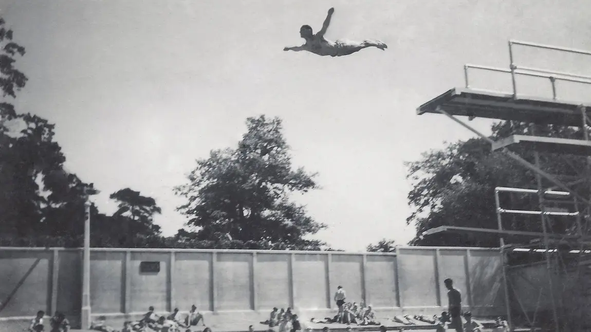 A man dives from the diving board at Broomhill Pool