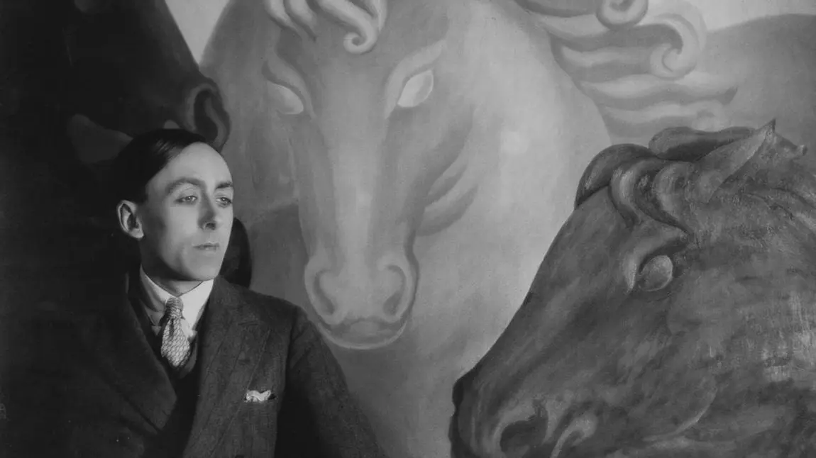 Eddy Sackville-West in front of a painting of horses 