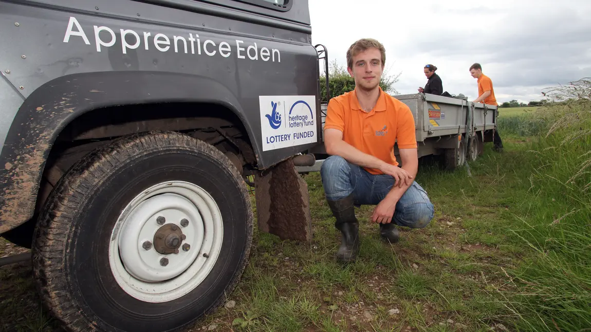 Joe posing next to the HLF logo