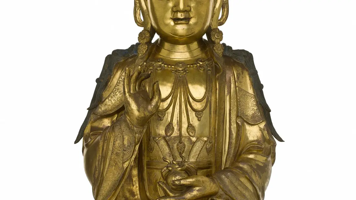 Figure of a bodhisattva in gilt bronze, holding a flaming jewel in left hand