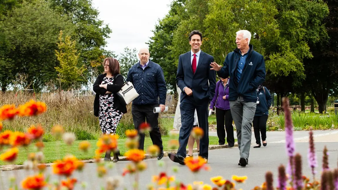 Ed Miliband walking through Bentley Park