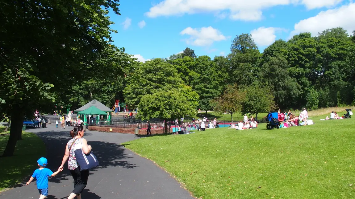 Families enjoying the sun in Thompson Park, Burnley