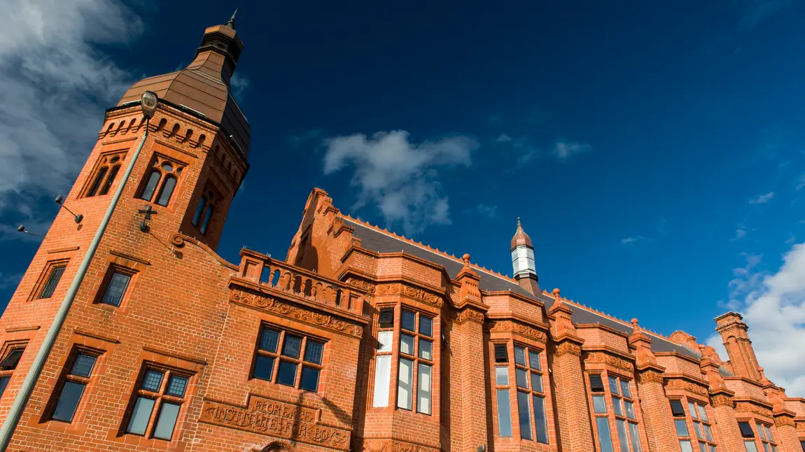 The Florrie; a redbrick building stands impressively in front of a blue sky