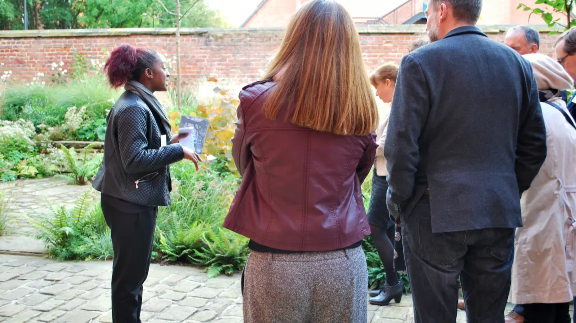 A woman gives a tour of a garden